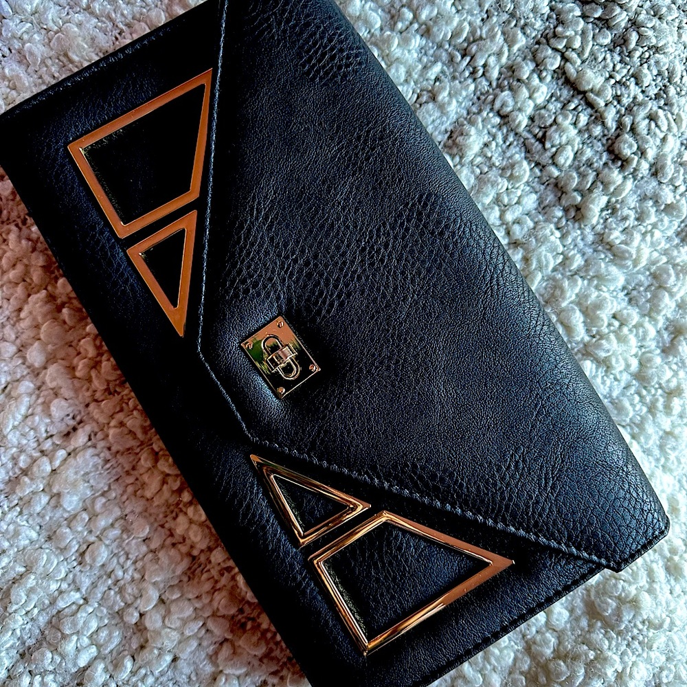 Stylish black clutch purse. Black with gold pieces